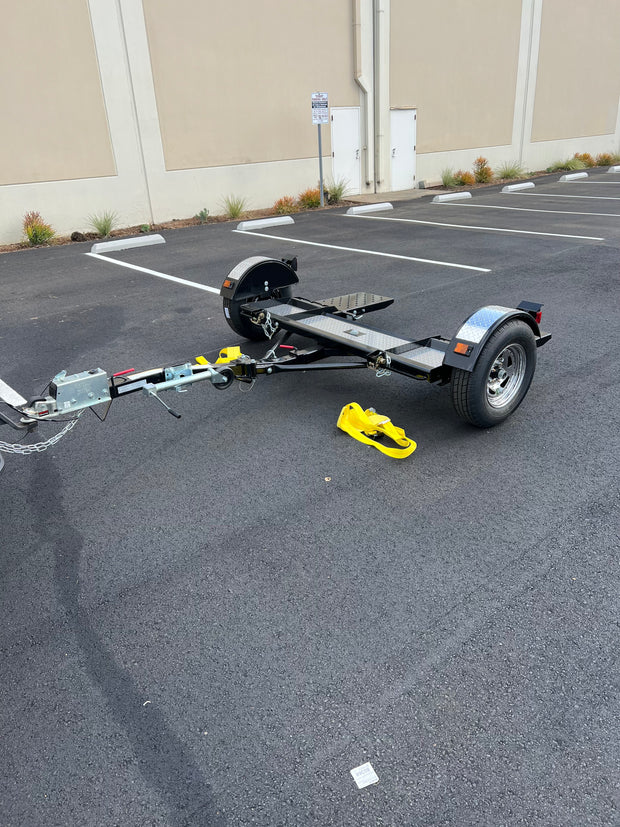 "Car tow dolly in action, equipped with Demco surge brakes"