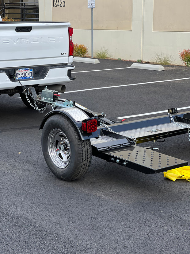 "Car tow dolly with pre-installed safety chains and Demco brakes"