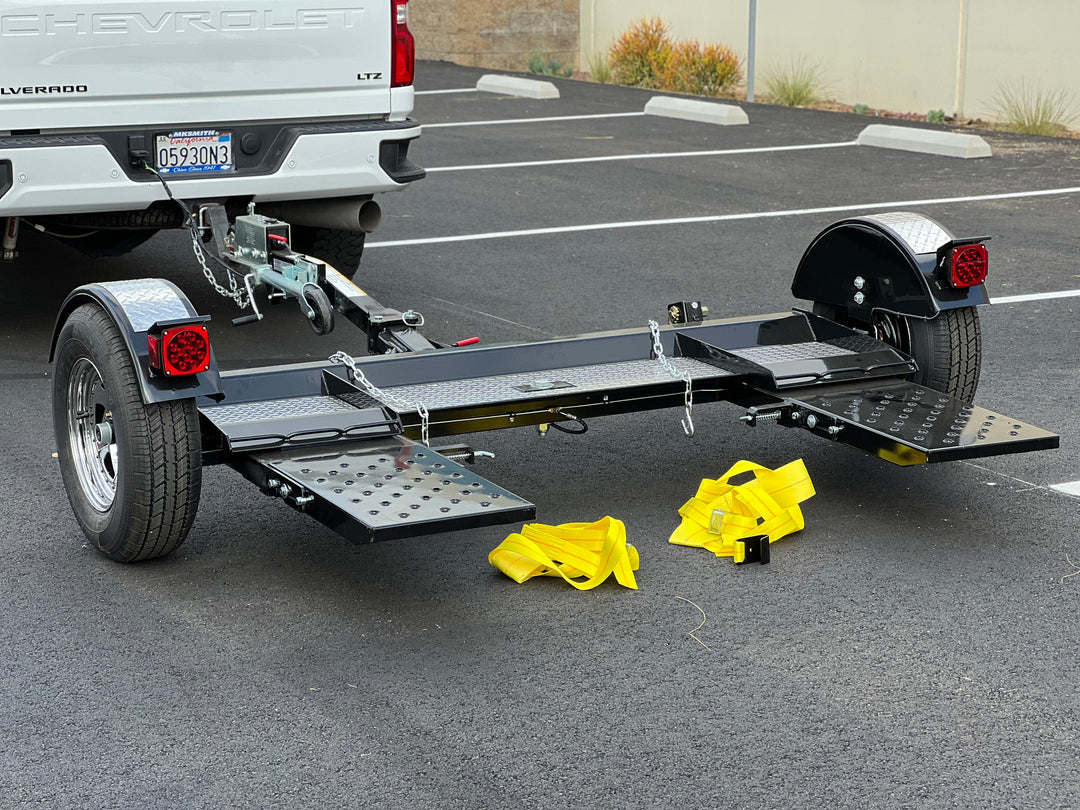 "Side profile of car tow dolly with secure straps and Demco brakes"