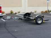 "Car tow dolly in stored position, optimized for small spaces"